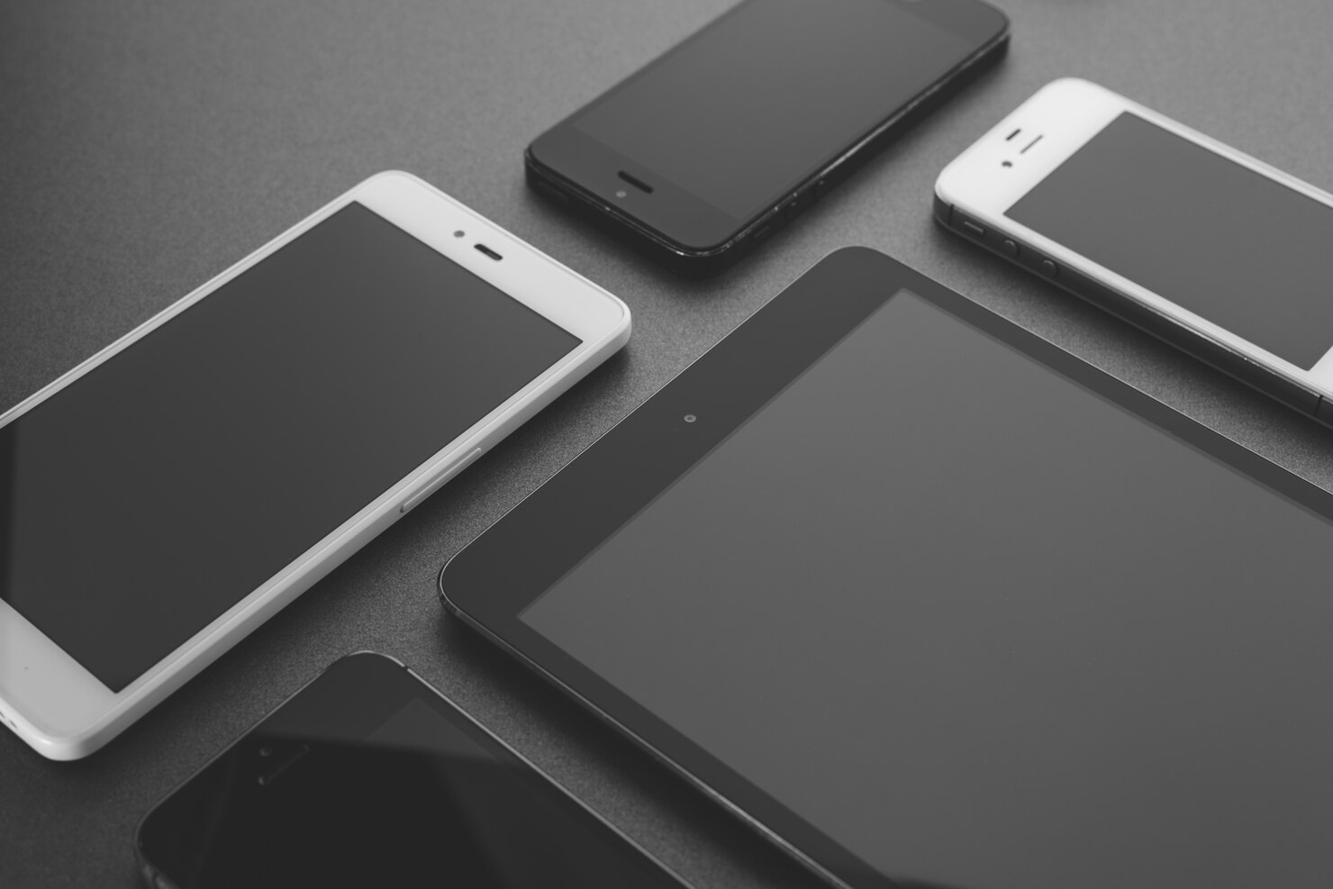 many different smart phones displayed dark background busy office scene 1372 28